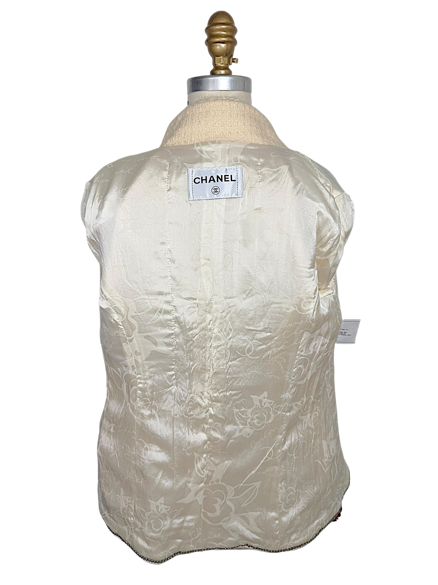 Interior of Chanel Pre-Fall 2010 jacket displaying signature ivory camellia jacquard silk lining and Chanel neck label.