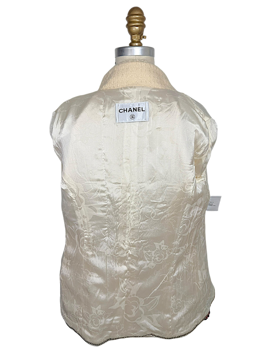 Interior of Chanel Pre-Fall 2010 jacket displaying signature ivory camellia jacquard silk lining and Chanel neck label.