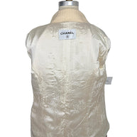 Interior of Chanel Pre-Fall 2010 jacket displaying signature ivory camellia jacquard silk lining and Chanel neck label.