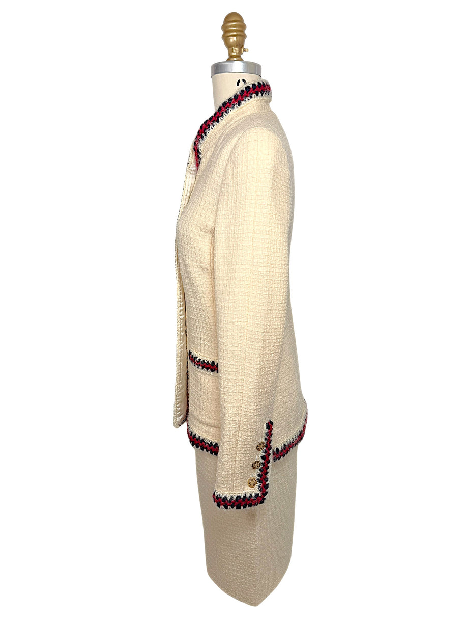 Opposite side profile of Chanel Pre-Fall 2010 ivory bouclé jacket with fitted silhouette and signature braided trim.
