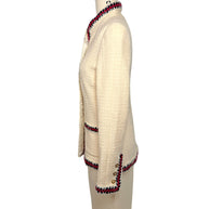 Opposite side profile of Chanel Pre-Fall 2010 ivory bouclé jacket with fitted silhouette and signature braided trim.