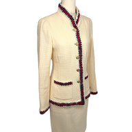 Three-quarter front view of Chanel Pre-Fall 2010 ivory bouclé jacket highlighting tailored silhouette and braided trim detailing.