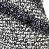 Close-up detail of Chanel silk ribbon trim and CC hardware accent