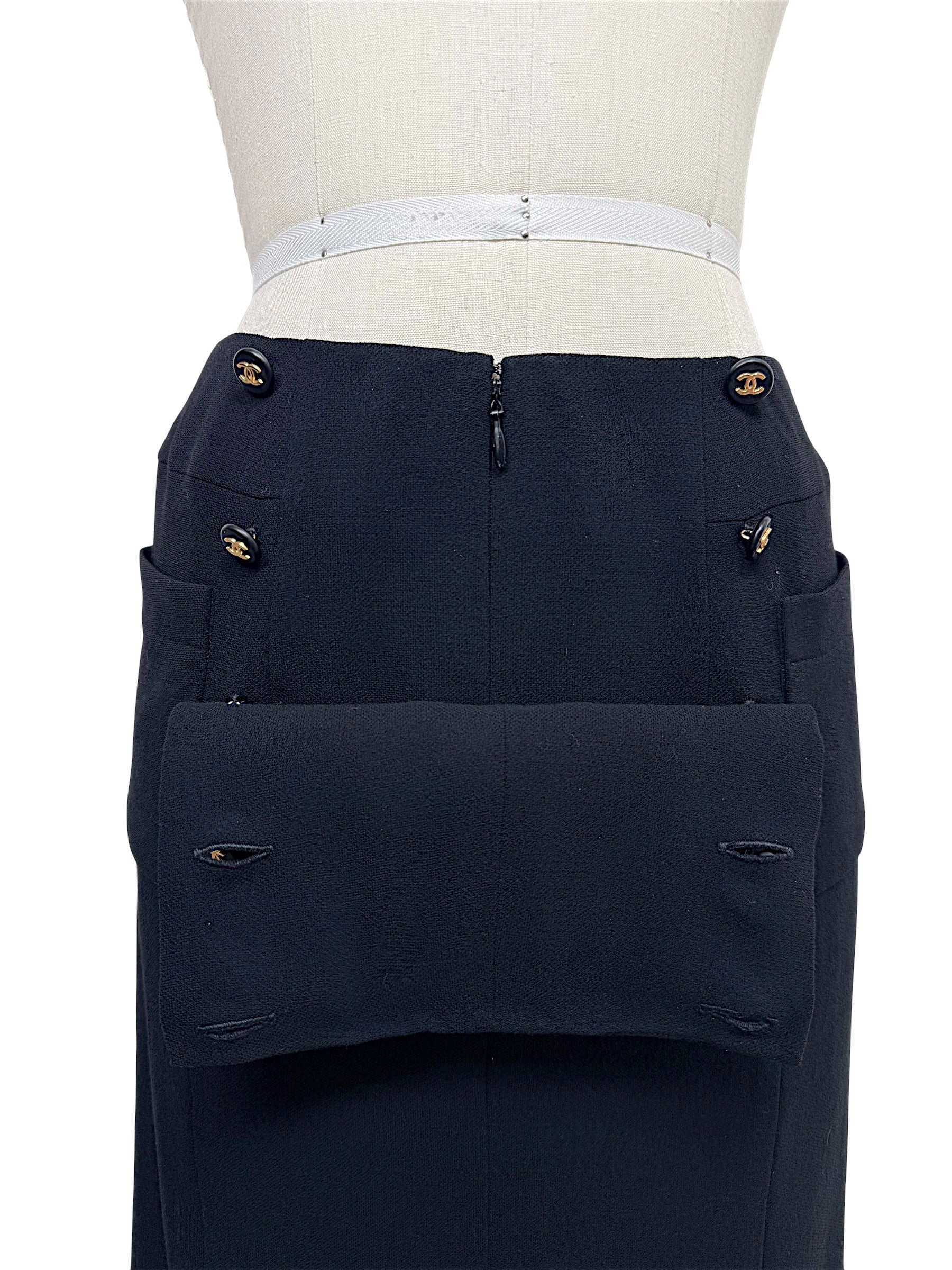 Close-up of vintage Chanel Spring 1997 black skirt with gold CC logo buttons and oversized patch pocket