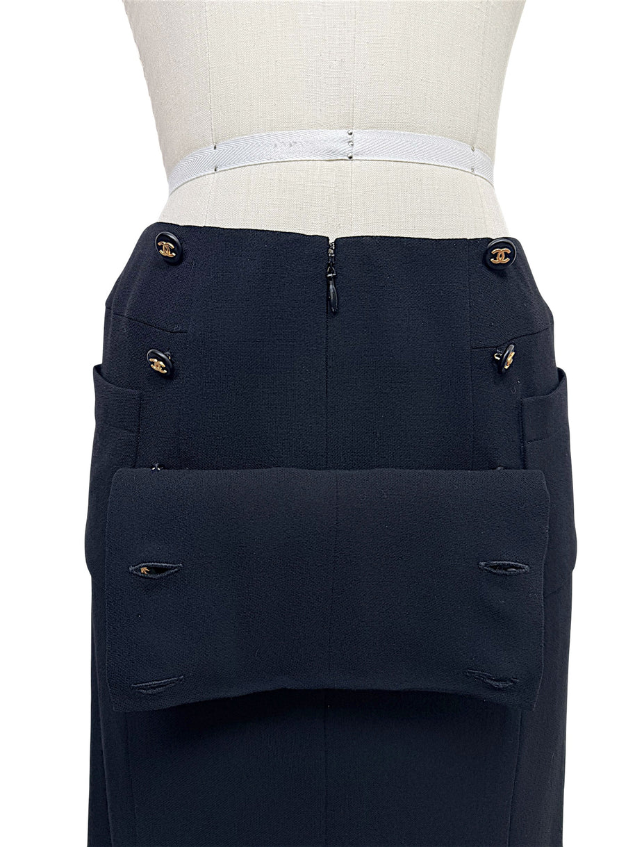 Close-up of vintage Chanel Spring 1997 black skirt with gold CC logo buttons and oversized patch pocket