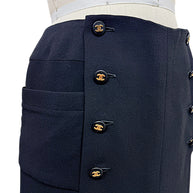 Chanel Spring 1997 black midi skirt showing concealed zipper, CC buttons and oversized front patch pocket