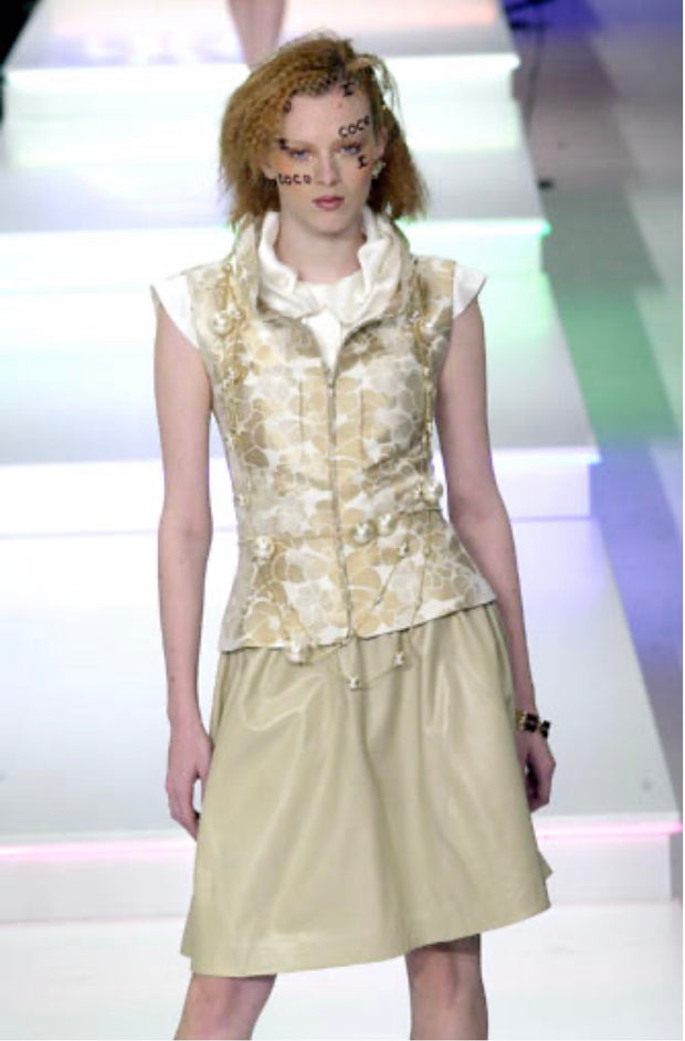 Chanel Spring Summer 2001 runway model wearing floral jacquard vest with pearl belt detail