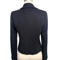 Rear view of Chanel Spring 2005 runway black bouclé cropped jacket highlighting tailored back construction and fitted silhouette.