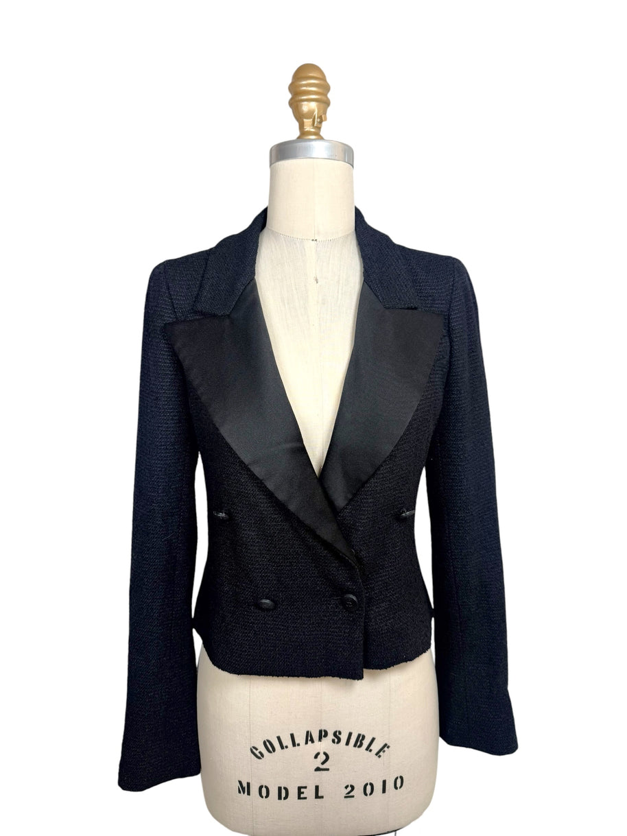 Documented Chanel Spring Summer 2005 runway black bouclé cropped tuxedo jacket featuring oversized satin peak lapels, double-breasted CC buttons and tailored silhouette.