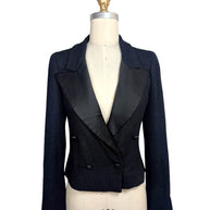 Documented Chanel Spring Summer 2005 runway black bouclé cropped tuxedo jacket featuring oversized satin peak lapels, double-breasted CC buttons and tailored silhouette.