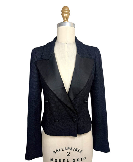 Documented Chanel Spring Summer 2005 runway black bouclé cropped tuxedo jacket featuring oversized satin peak lapels, double-breasted CC buttons and tailored silhouette.