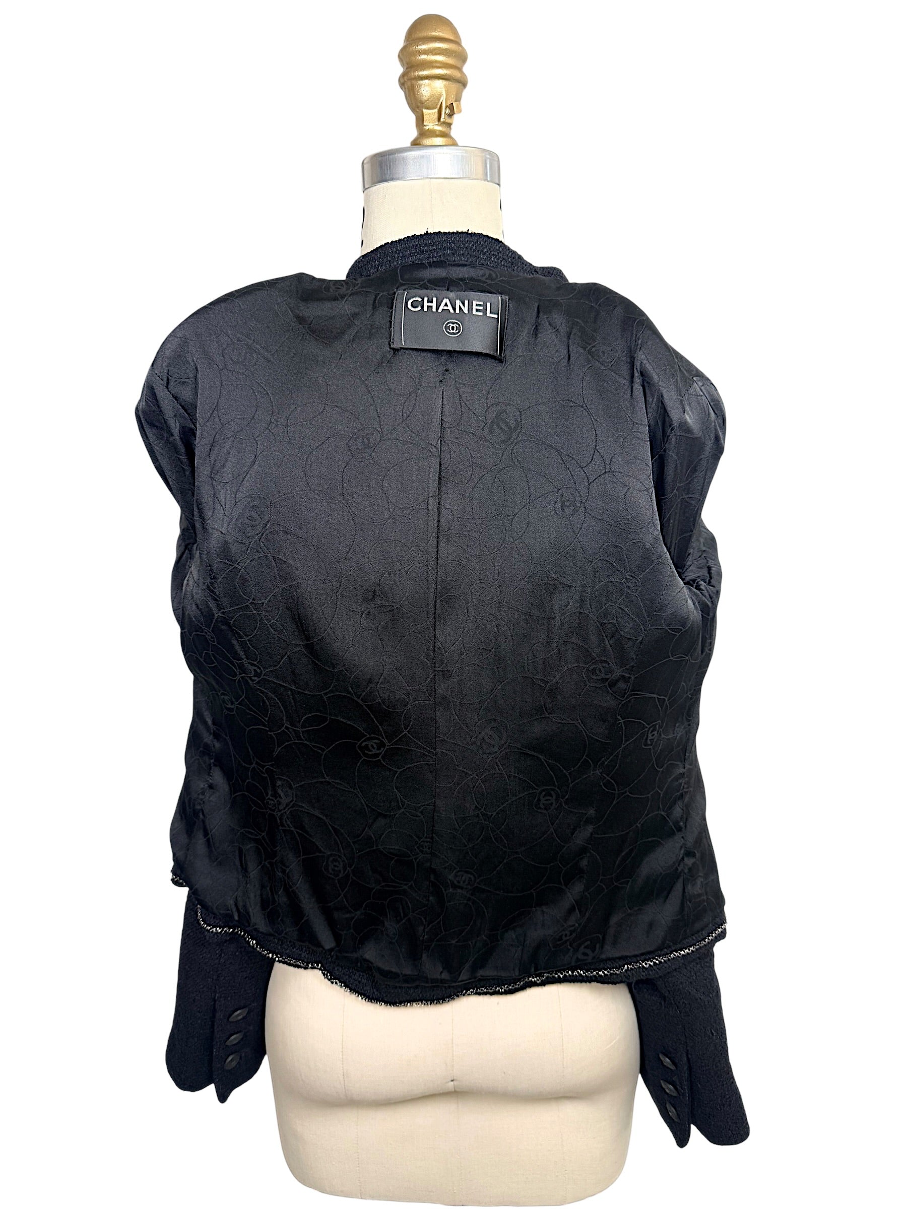 Interior of Chanel Spring Summer 2005 runway jacket featuring black camellia jacquard silk lining and luxury tailoring.