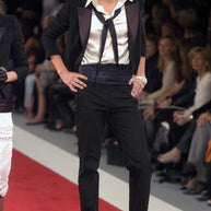 Documented Chanel Spring Summer 2005 runway look featuring the black cropped bouclé tuxedo jacket styled by Karl Lagerfeld.
