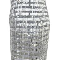 Detail of small mid hip area with missing metallic material on Chanel silver woven skirt.