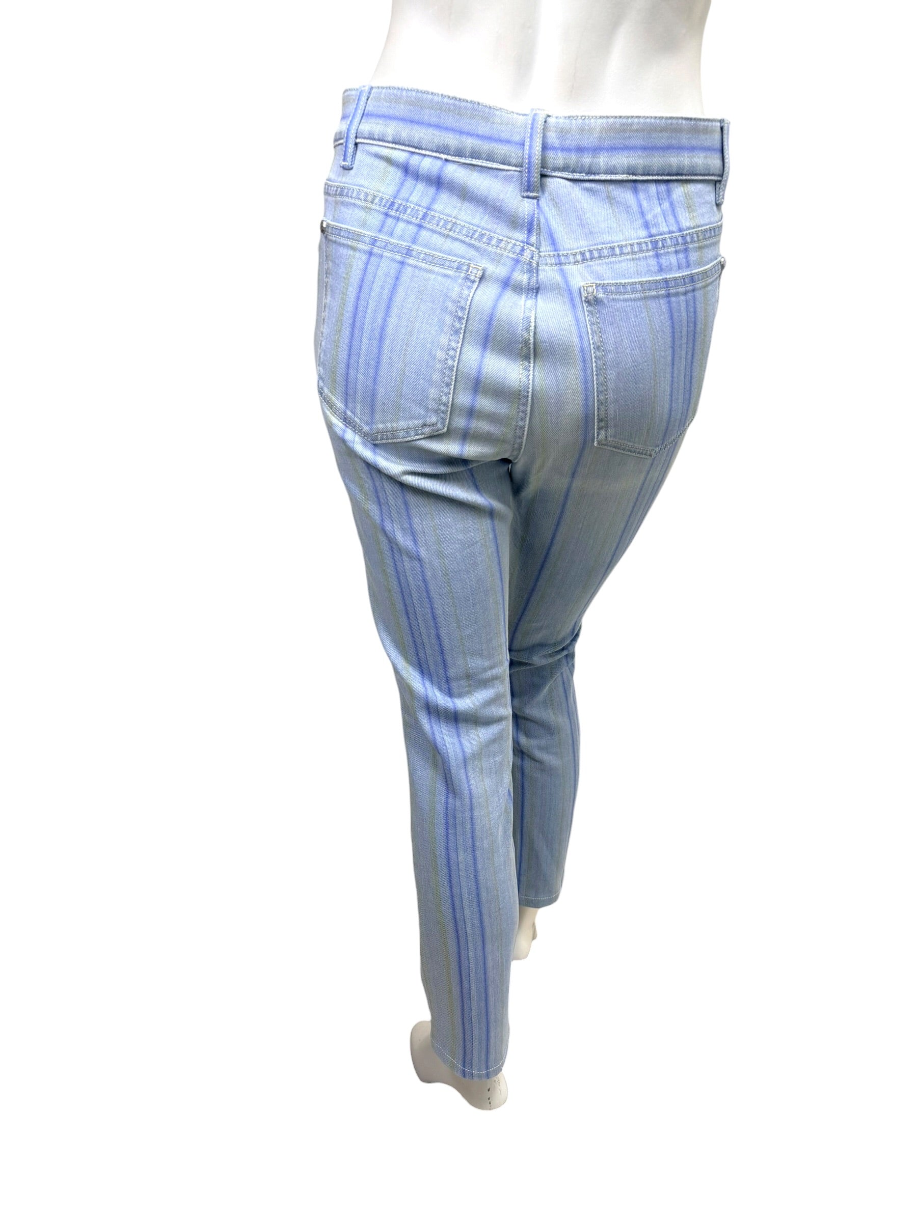 Rear view of Chanel pale blue striped denim jeans with tonal vertical stripe pattern and slim ankle cut.
