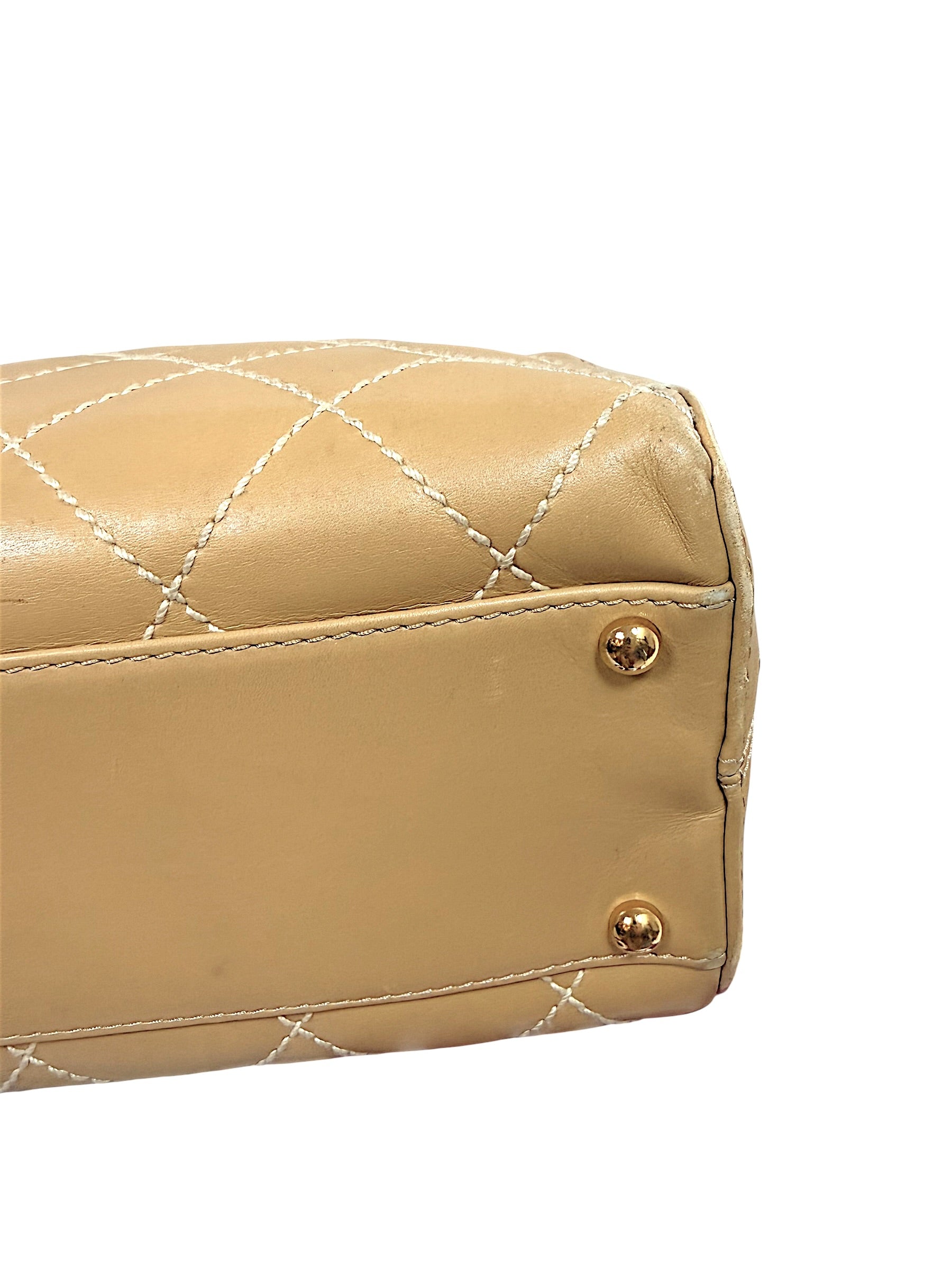 Close-up detail of Chanel Surpique Bowler bag bottom corner and protective feet showing condition.