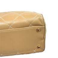 Close-up detail of Chanel Surpique Bowler bag bottom corner and protective feet showing condition.