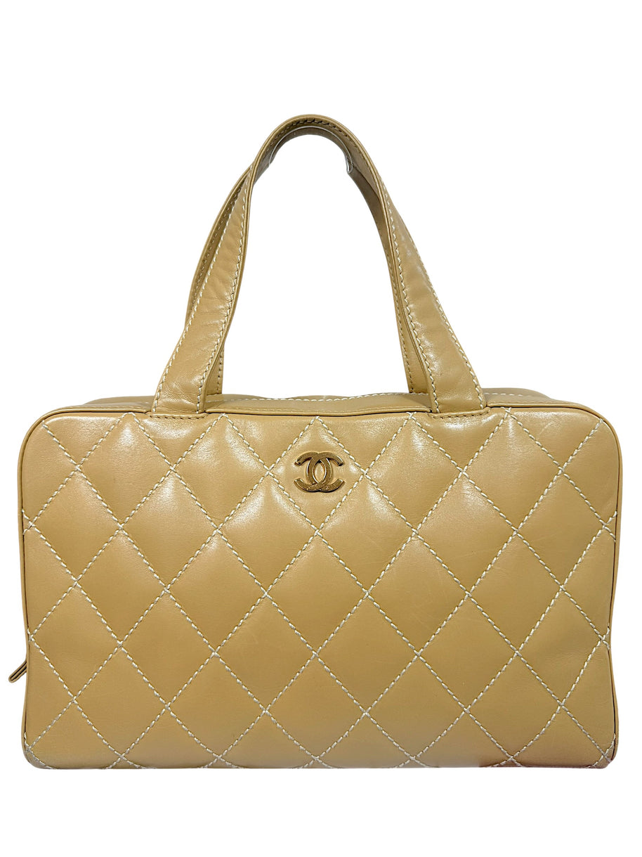 Vintage Chanel Surpique Bowler bag from the 2002–2003 collection in beige quilted lambskin leather with contrast stitching and gold CC logo detail front view.
