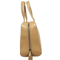 Side profile of vintage Chanel Surpique Bowler bag in beige quilted lambskin featuring top zip closure and rolled leather handles.