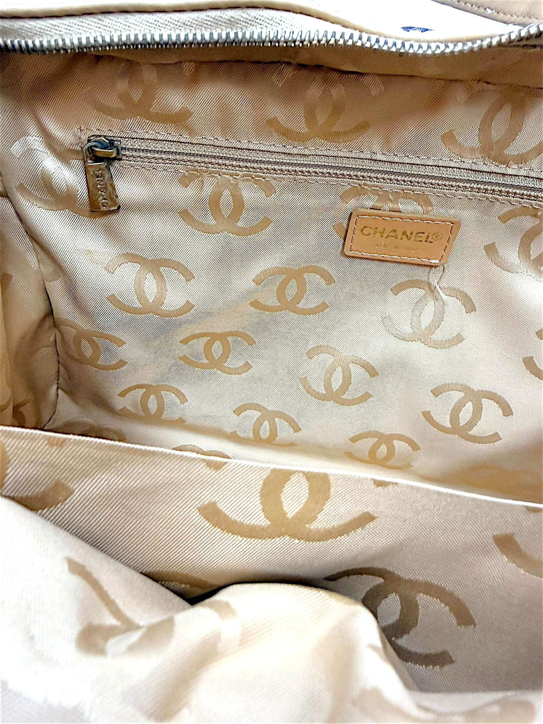 Full interior view of vintage Chanel Surpique Bowler bag featuring CC jacquard lining and zip storage pocket.