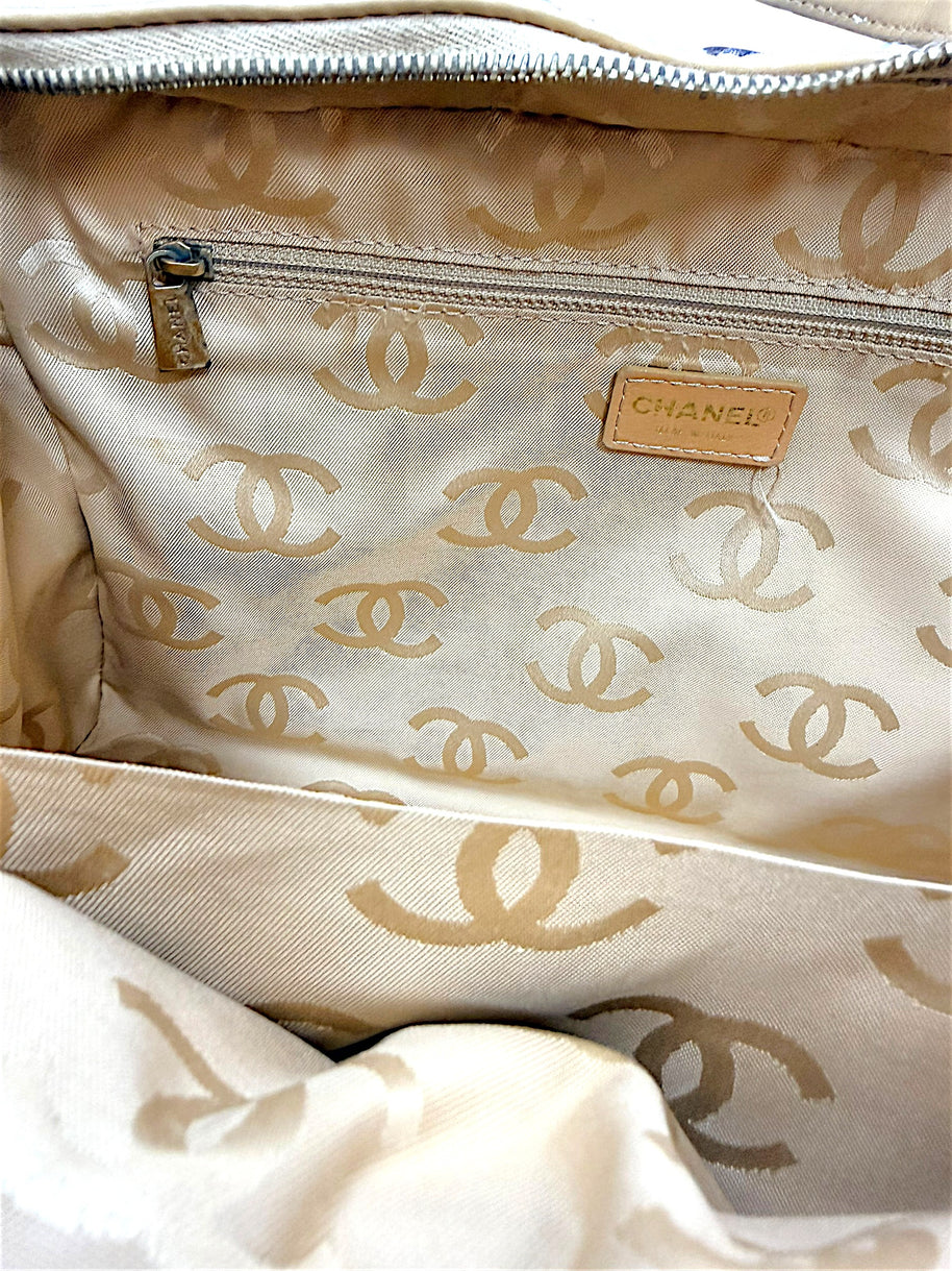Full interior view of vintage Chanel Surpique Bowler bag featuring CC jacquard lining and zip storage pocket.