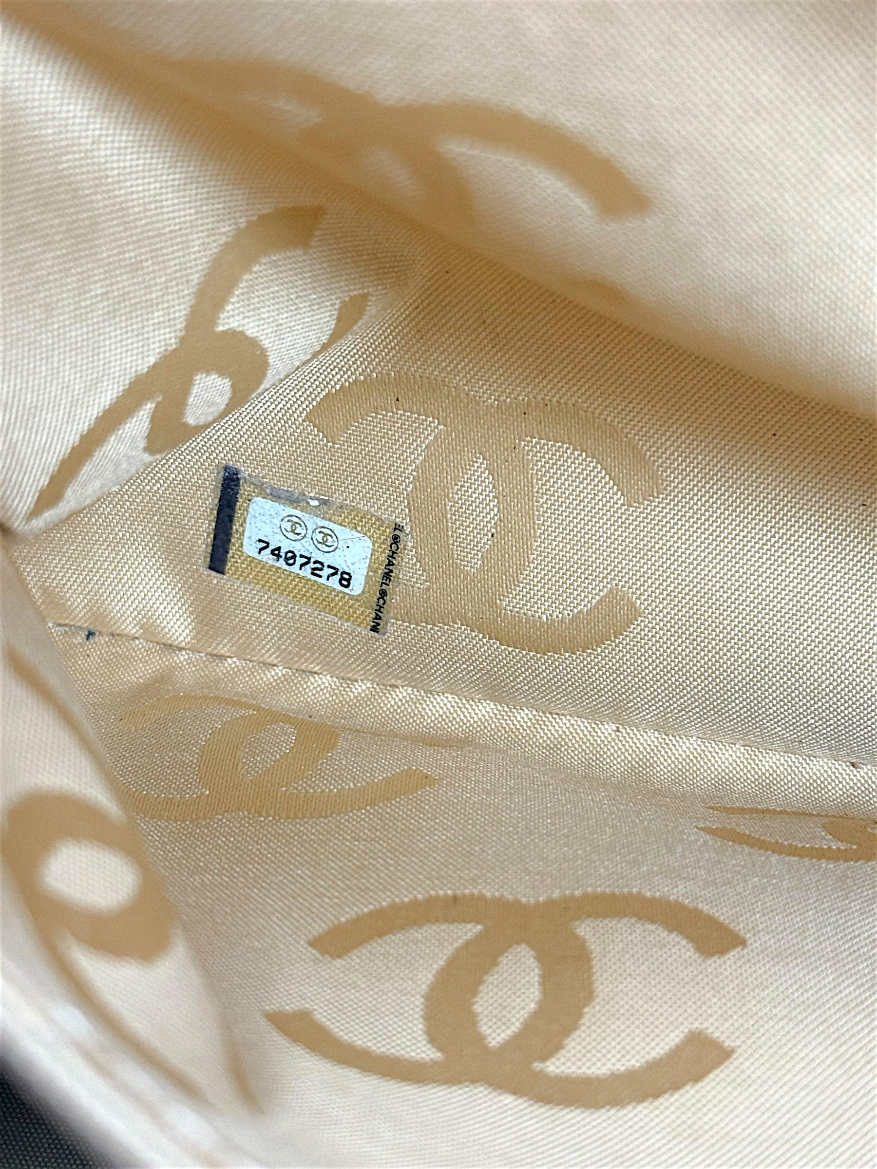 Original Chanel hologram serial sticker inside vintage Surpique Bowler bag dating to 2002–2003 collection.