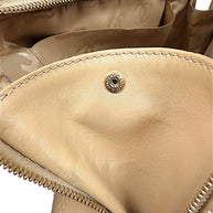 Interior Chanel hardware snap detail inside vintage beige lambskin Surpique Bowler bag.