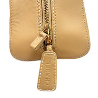 Close-up of embossed CHANEL leather zipper pull with contrast stitching on vintage Chanel Surpique Bowler bag.