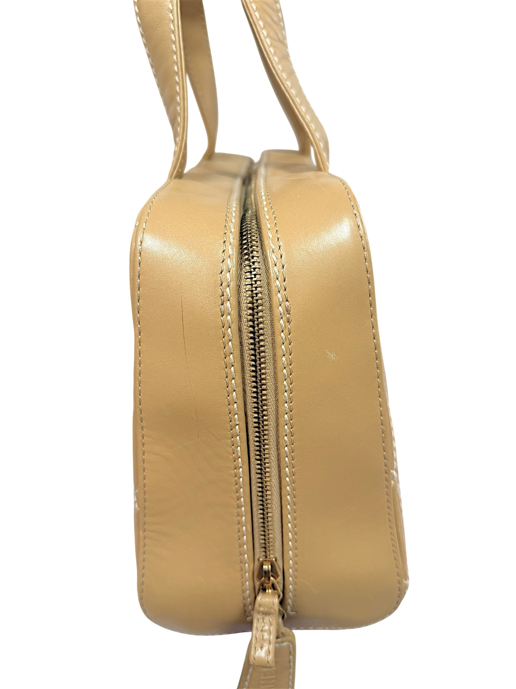 Close-up side detail of Chanel Surpique Bowler bag showing quilting, lambskin leather texture and zipper construction.