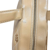 Close-up top handle detail of Chanel vintage beige lambskin Surpique Bowler bag.