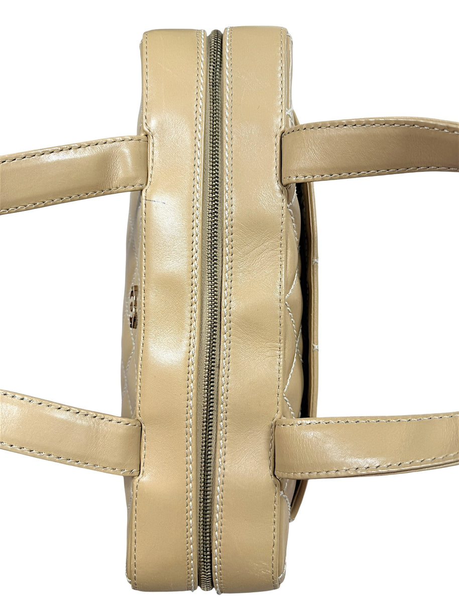 Top view of Chanel Surpique Bowler bag showing zipper construction and rolled leather handles.