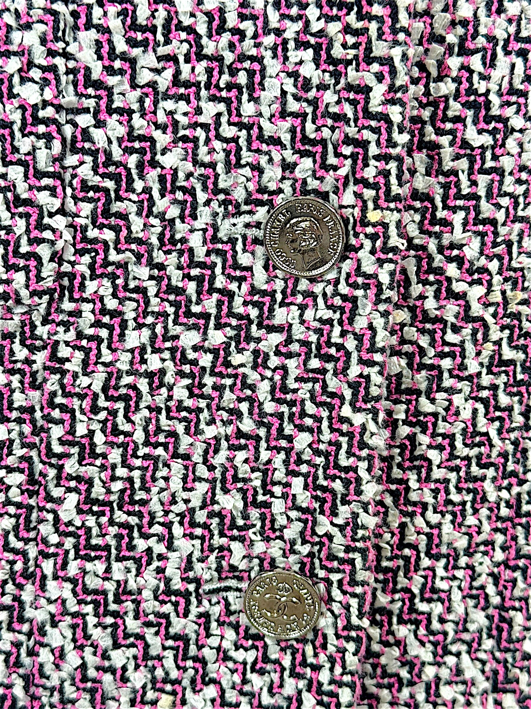 Macro detail of Chanel pink black and white tweed weave with silver-tone CC buttons from Spring 1996 collection