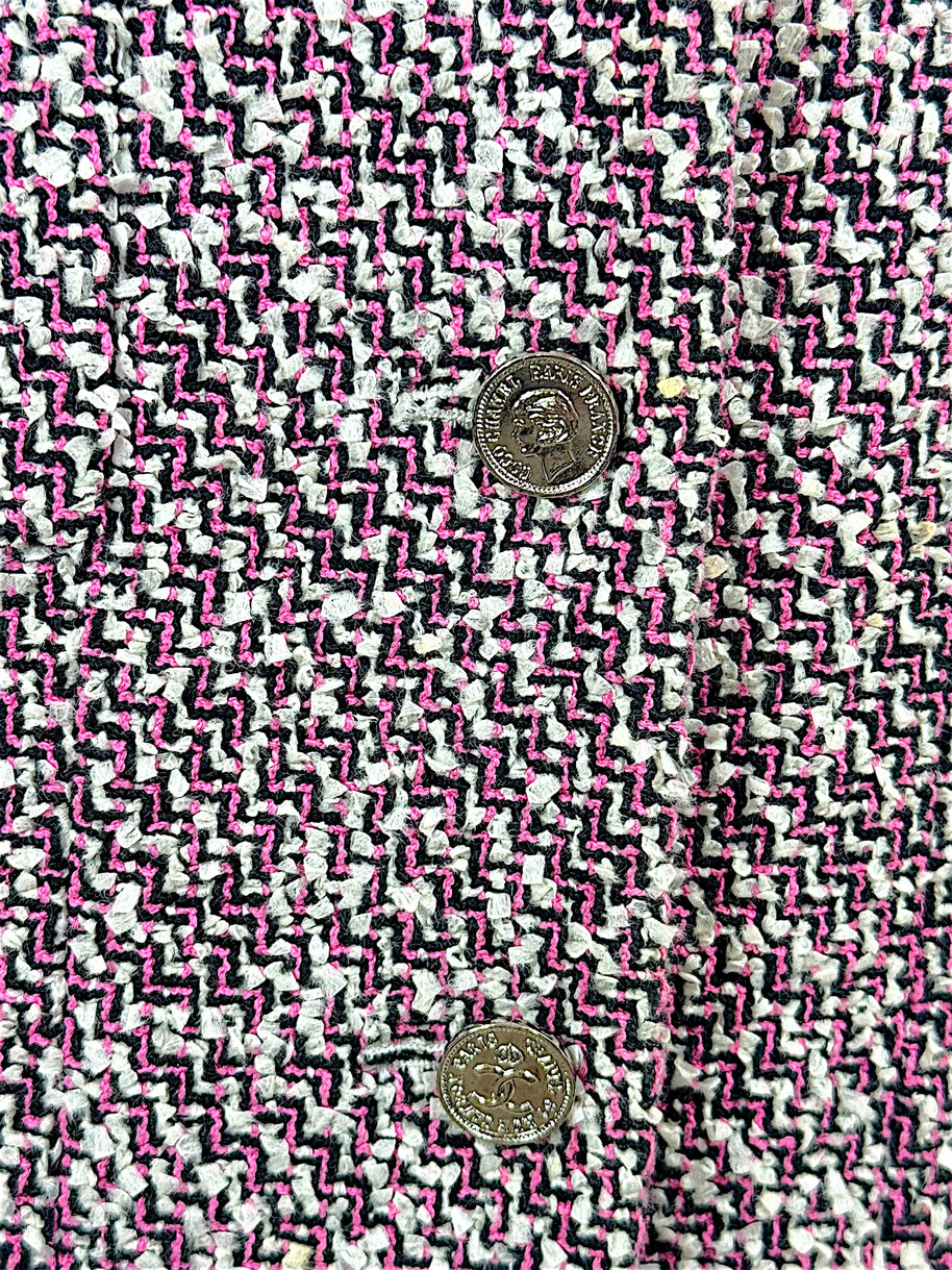Macro detail of Chanel pink black and white tweed weave with silver-tone CC buttons from Spring 1996 collection