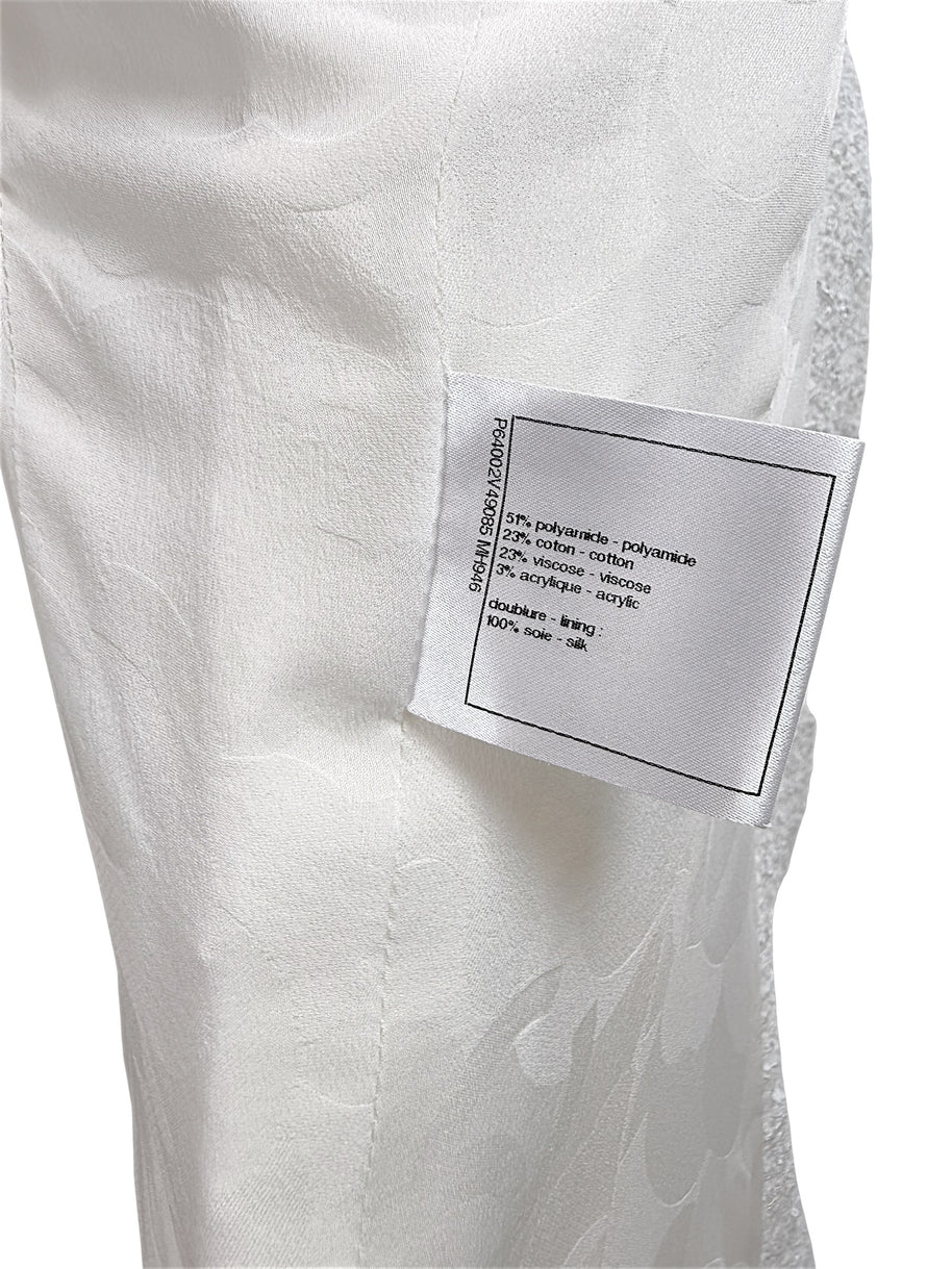 Fabric composition tag inside Chanel white bouclé tweed dress with silk lining and metallic trim