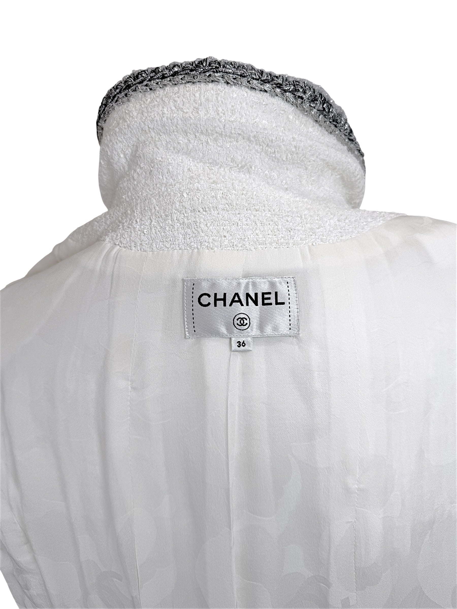 Interior Chanel label inside white bouclé tweed dress showing size FR 36 and silk lining