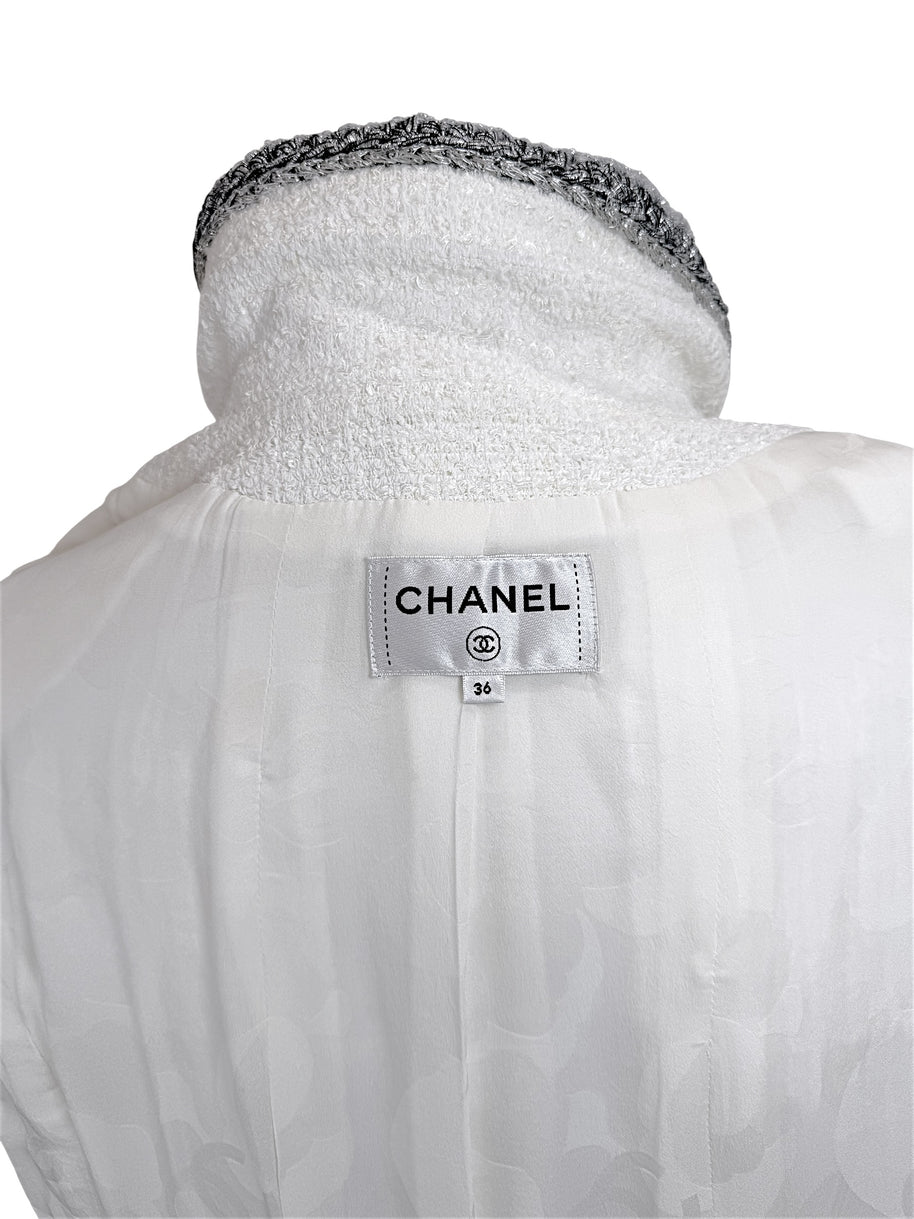 Interior Chanel label inside white bouclé tweed dress showing size FR 36 and silk lining