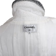 Interior Chanel label inside white bouclé tweed dress showing size FR 36 and silk lining