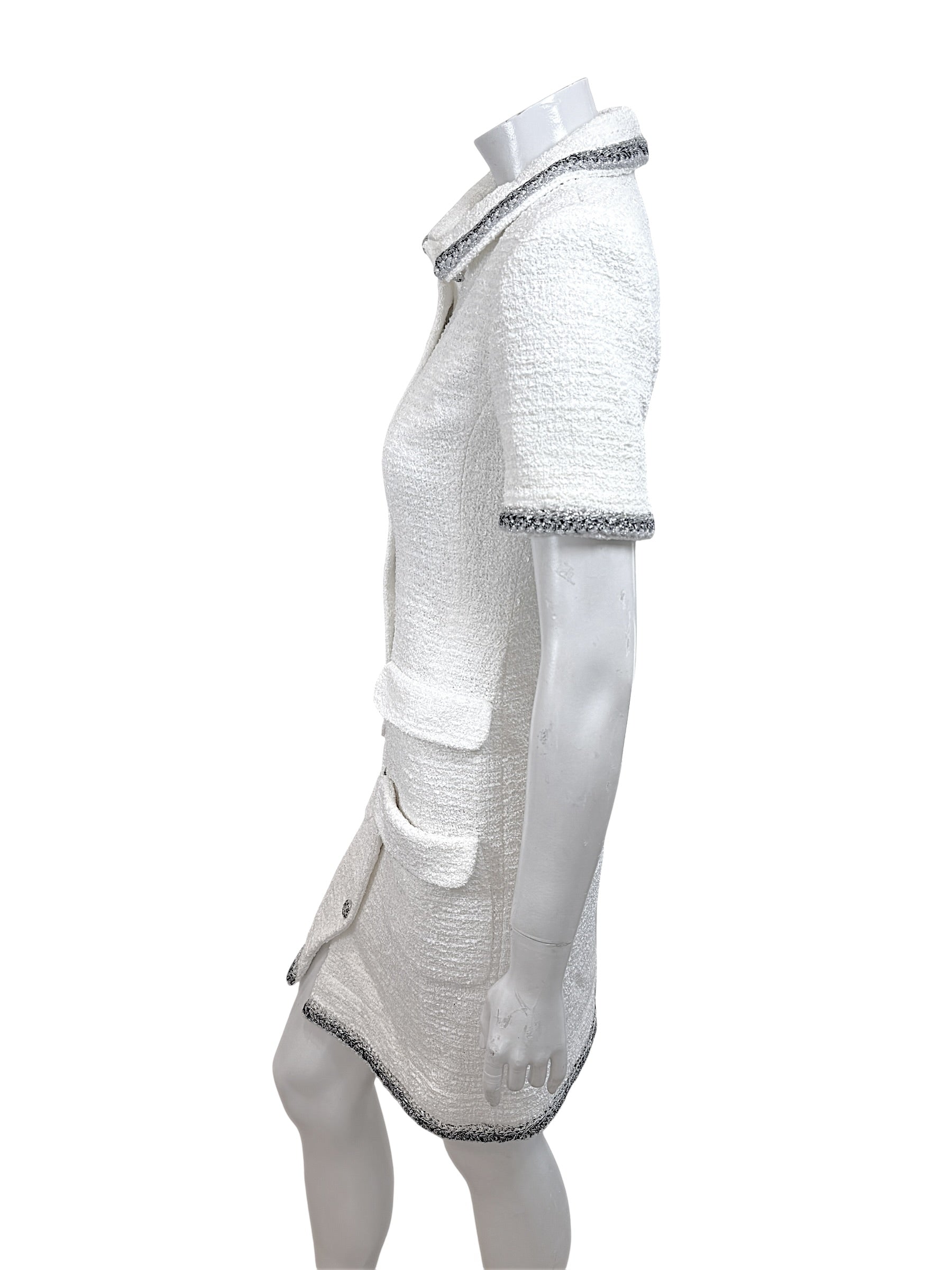 Side profile view of Chanel white bouclé tweed dress with tailored silhouette and metallic trim detailing