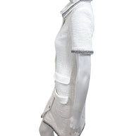 Side profile view of Chanel white bouclé tweed dress with tailored silhouette and metallic trim detailing