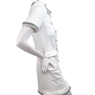 Right side profile of Chanel white bouclé tweed button front dress with short sleeves and fitted silhouette