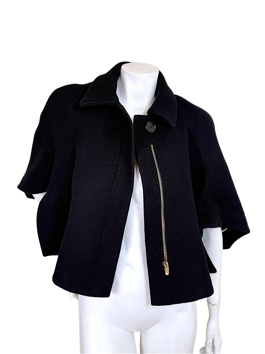 Chloé black wool cropped cape jacket from Fall 2013 shown open with gold-tone asymmetric zipper and cape sleeves