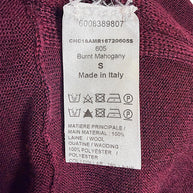 Chloé wool sweater dress interior care and composition label showing size S, Burnt Mahogany color 605, 100% wool main material and Made in Italy.