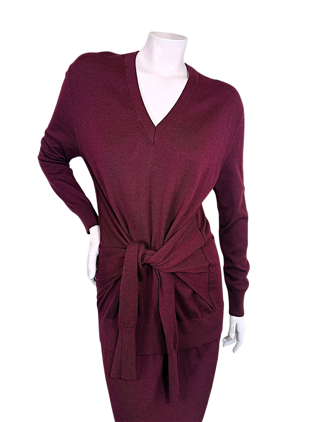 Close front view of Chloé Fall 2019 burgundy wool knit dress showing ribbed V-neckline, relaxed sweater silhouette and knotted waist tie detail.