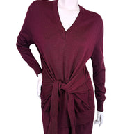 Close front view of Chloé Fall 2019 burgundy wool knit dress showing ribbed V-neckline, relaxed sweater silhouette and knotted waist tie detail.