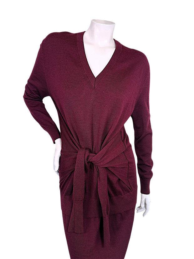 Close front view of Chloé Fall 2019 burgundy wool knit dress showing ribbed V-neckline, relaxed sweater silhouette and knotted waist tie detail.