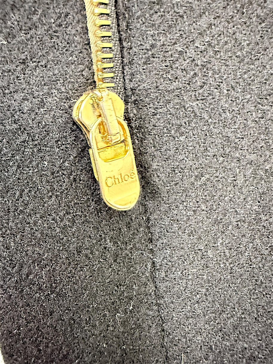 Close-up of gold-tone Chloé logo zipper pull on black Fall 2013 wool cape jacket