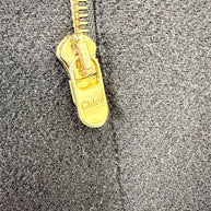 Close-up of gold-tone Chloé logo zipper pull on black Fall 2013 wool cape jacket