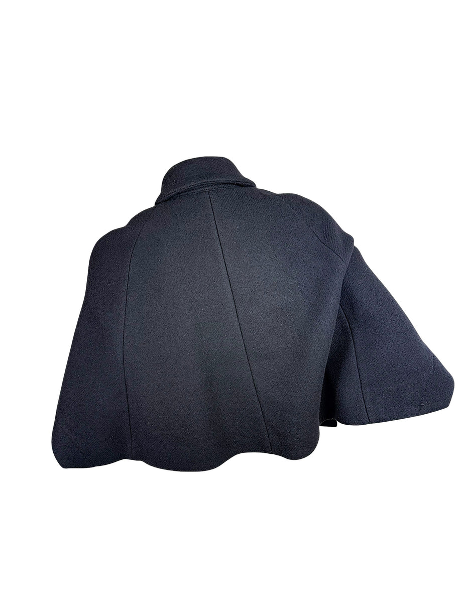 Back view of Chloé Fall 2013 black wool cropped cape jacket showing curved panel seams and flared hem