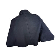 Back view of Chloé Fall 2013 black wool cropped cape jacket showing curved panel seams and flared hem