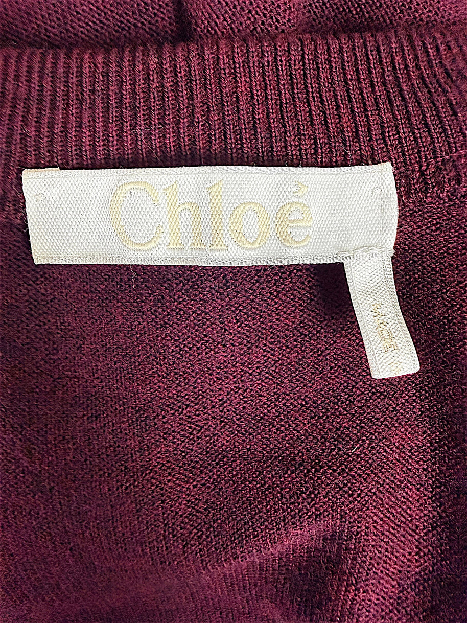 Close-up of Chloé designer label sewn inside the Burnt Mahogany wool tie-front sweater dress from the Fall 2019 collection.